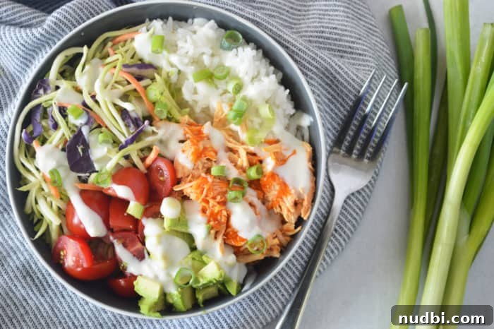Buffalo chicken rice bowl on striped napkin