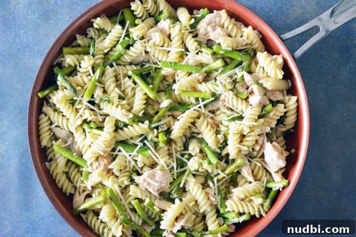 Kickstart Your Year with 28 Wholesome Recipes 7 Fresh Lemon Dill Salmon Pasta with Asparagus in a serving bowl.
