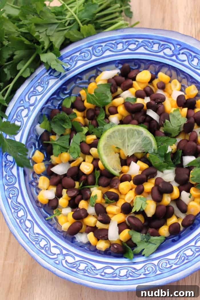 Black Bean and Corn Salsa in a bowl with tortilla chips.