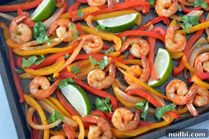 Sheet Pan Shrimp Fajitas with colorful bell peppers and onions.