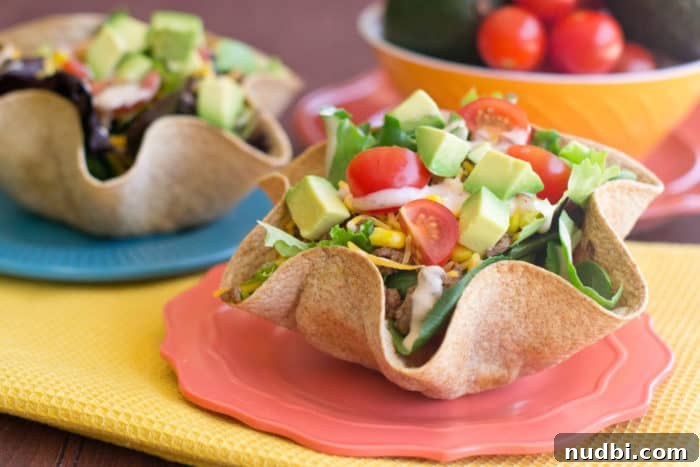 Tex-Mex Taco Salad Bowls with ground meat, lettuce, corn, and beans.
