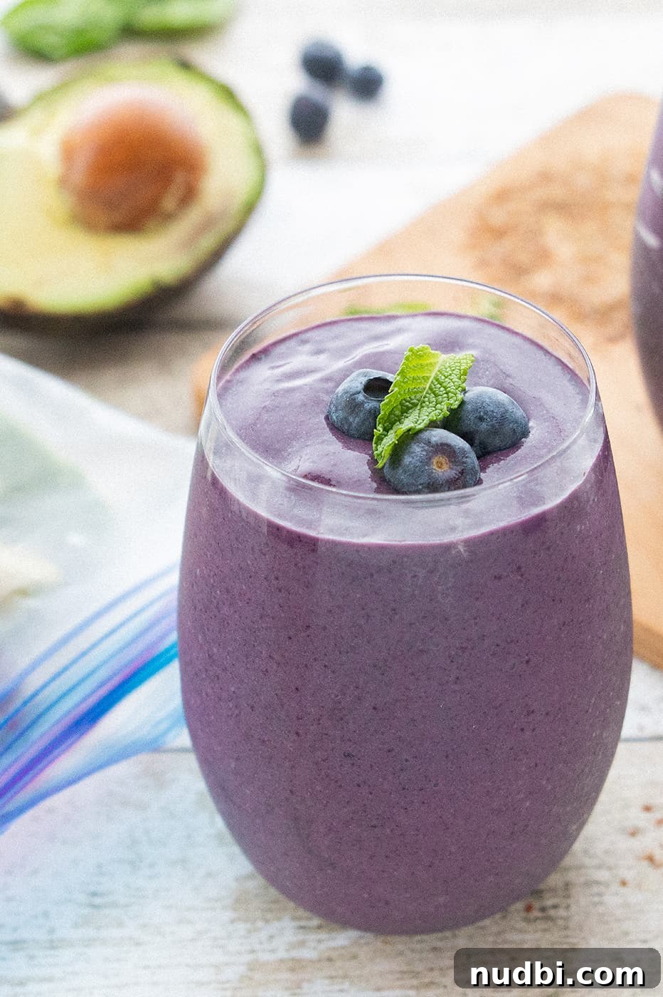 DIY Smoothie Bar Printable and Recipe Kit 5 A creamy purple blueberry avocado smoothie in a glass jar.