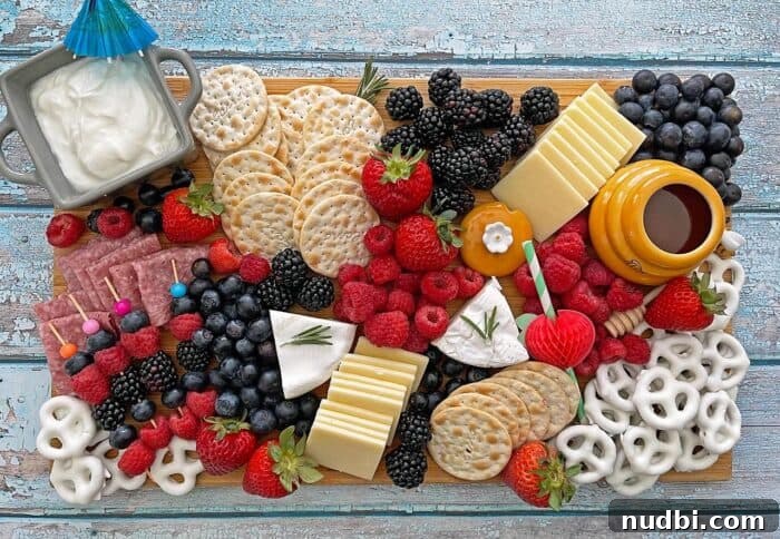 Sizzling Summer BBQ Inspirations 3 Festive patriotic charcuterie board with red berries, white cheeses, and blue crackers, ideal for a themed summer cookout.