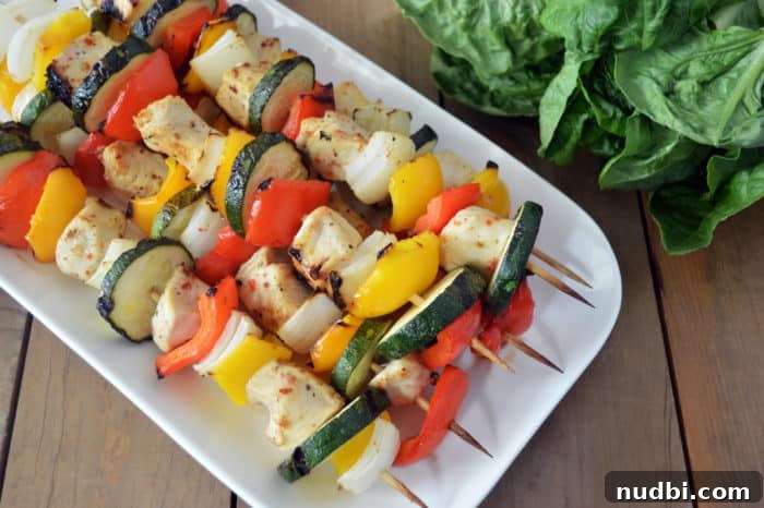 Sizzling Summer BBQ Inspirations 5 Grilled chicken and vegetable kebobs with bell peppers, onions, and zucchini, perfectly charred and ready to serve.