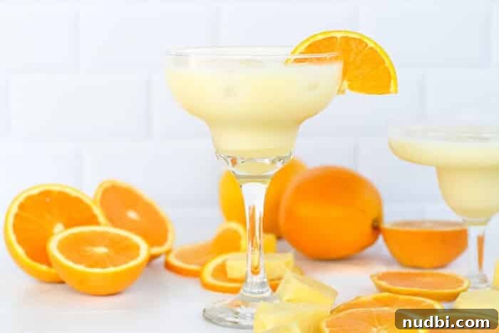 Sizzling Summer BBQ Inspirations 8 Vibrant orange pineapple coconut mocktail, garnished with fresh fruit, perfect for keeping guests refreshed at a summer cookout.