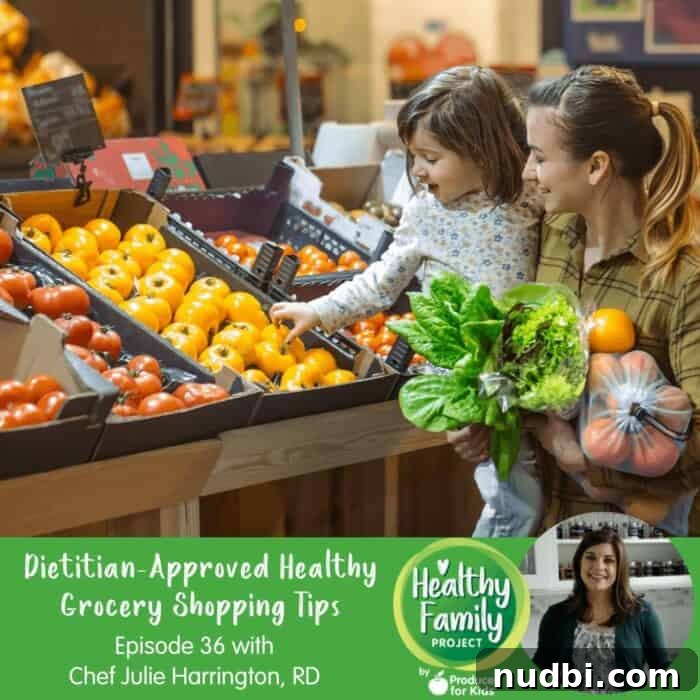 Episode 36: Dietitian's Guide to Smart Healthy Grocery Hauls 2 Julie Harrington, RD, at the grocery store, holding a shopping cart with fresh produce.