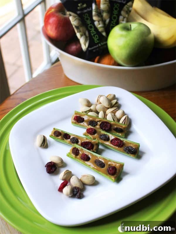 Ants & Friends on a Log snack made with celery, peanut butter, and raisins