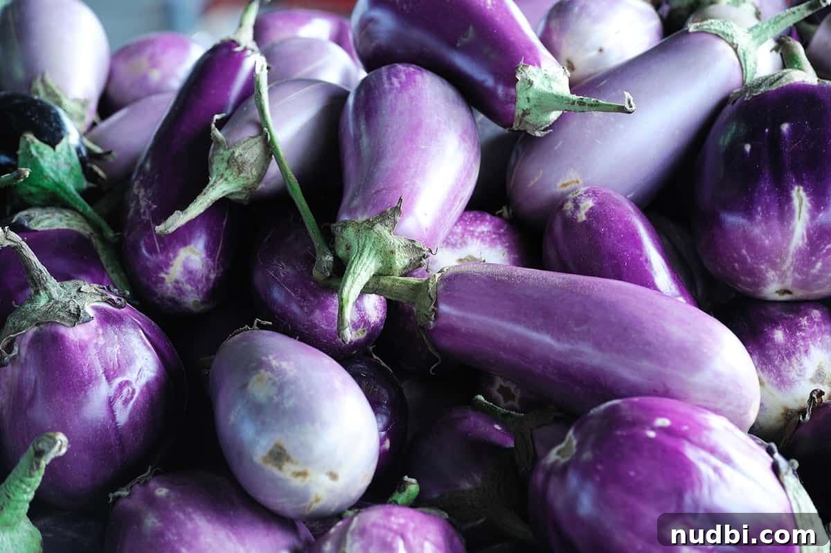 Piles of fresh, glossy eggplants