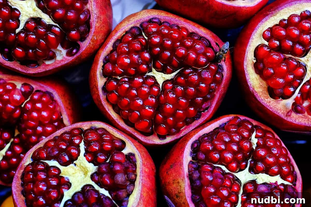 Close-up of cut pomegranates, showing juicy arils
