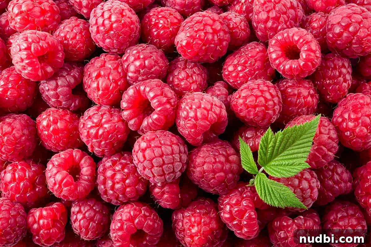 Fresh raspberries with a mint leaf garnish