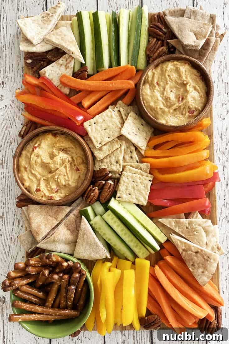 Hummus Snack Board with colorful veggies and pita