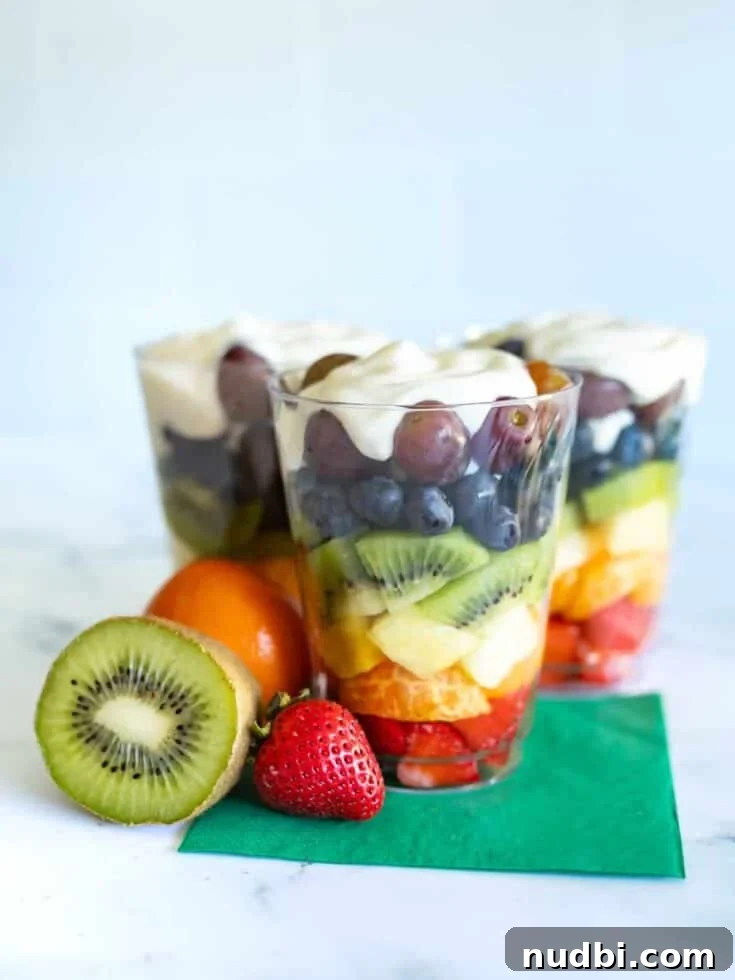 Rainbow fruit and yogurt parfaits in clear glasses
