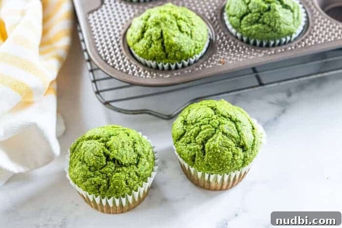 Healthy green spinach muffins on a white plate