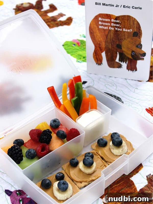 A Brown Bear Bento Box featuring a rainbow fruit salad, inspired by Brown Bear, Brown Bear, What Do You See?