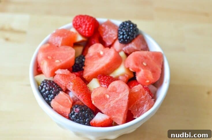A festive fruit salad with heart-shaped fruit pieces, ideal for Valentine's Day.