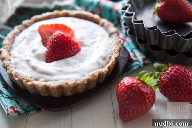 A slice of a 5-ingredient no-bake strawberry tart, topped with fresh strawberries.
