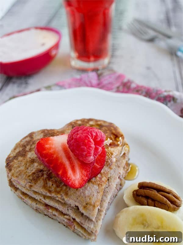 Stack of flourless raspberry banana pancakes, a healthy breakfast option.