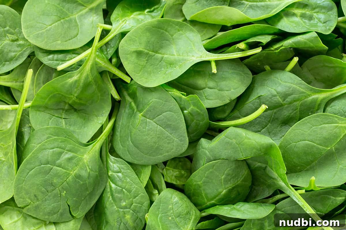 A pile of fresh, vibrant spinach leaves, highlighting the benefits of dark leafy greens for anxiety.
