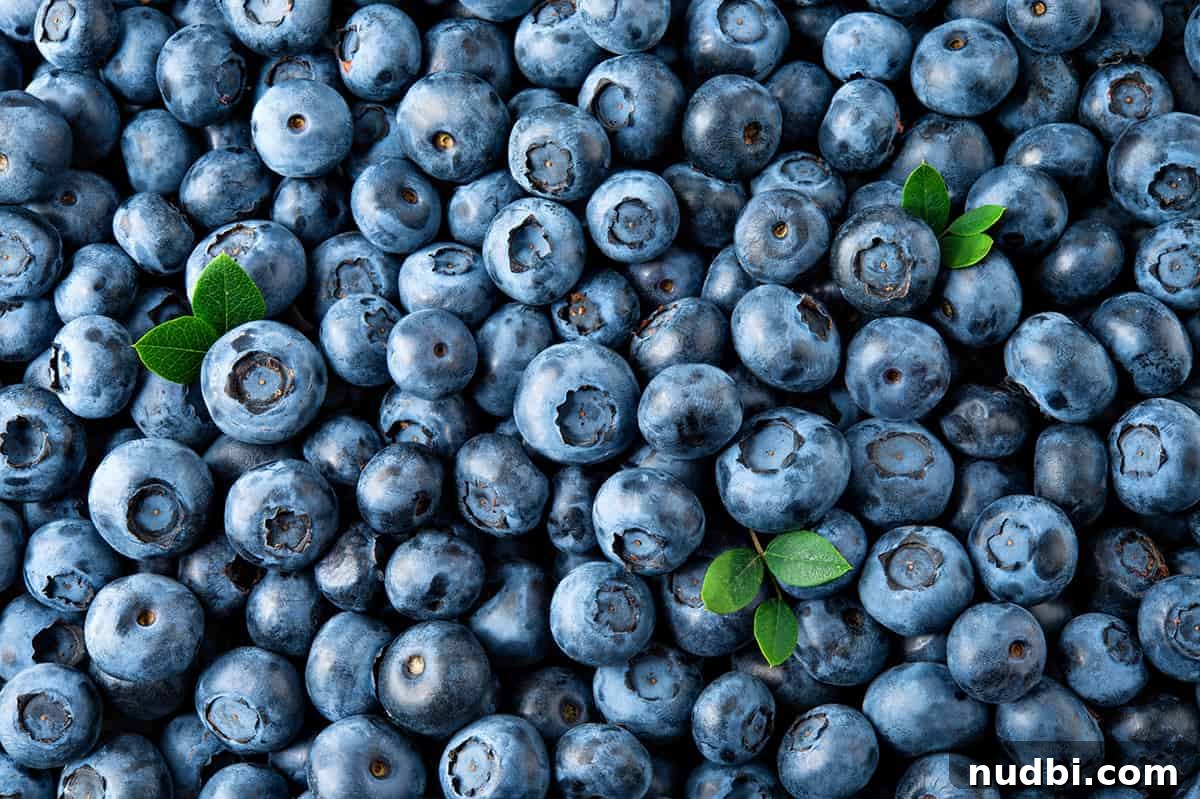 A vibrant bowl of fresh blueberries, emphasizing their role as anxiety-fighting foods.