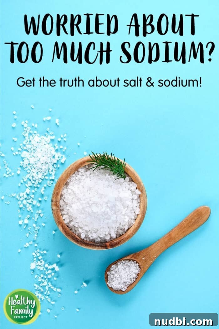 A child's hand reaching for a salt shaker, symbolizing the pervasive presence of salt in children's diets and the need for parental awareness.