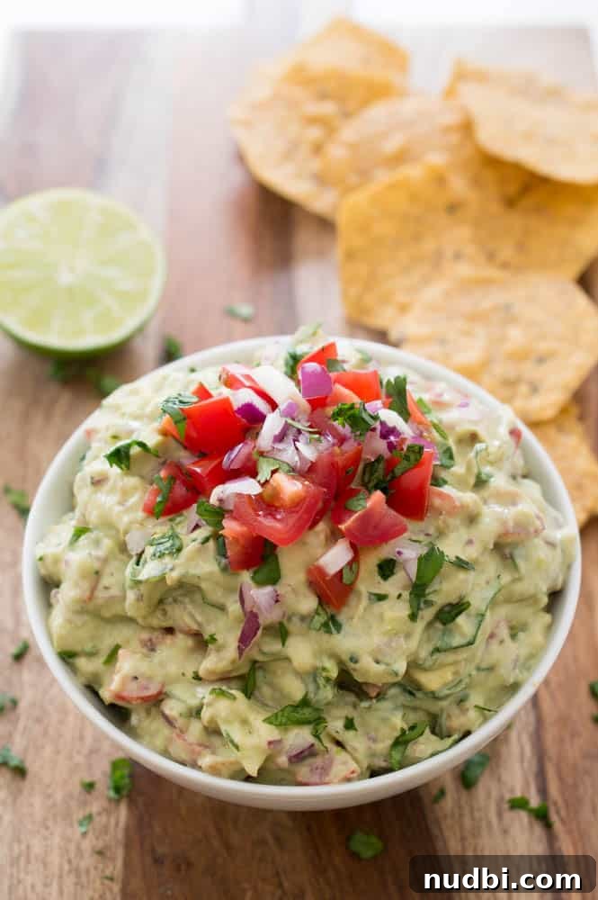 Healthy Greek Yogurt Guacamole topped with herbs