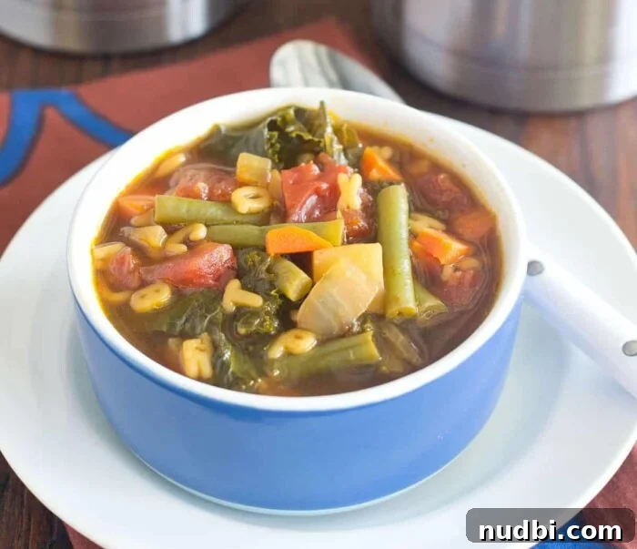 22 Wholesome Warm Lunchbox Delights 2 A steaming bowl of alphabet vegetable soup, perfect for a warm lunchbox.