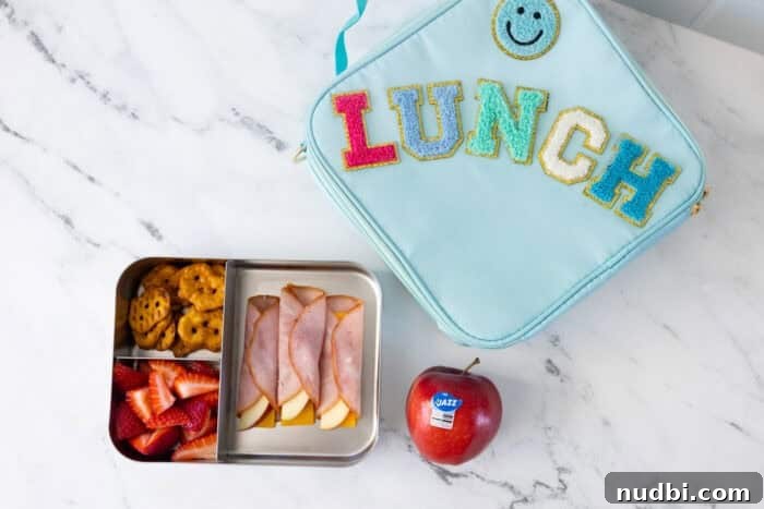 JAZZ apples and other school supplies on a desk, inspiring healthy back-to-school lunches.