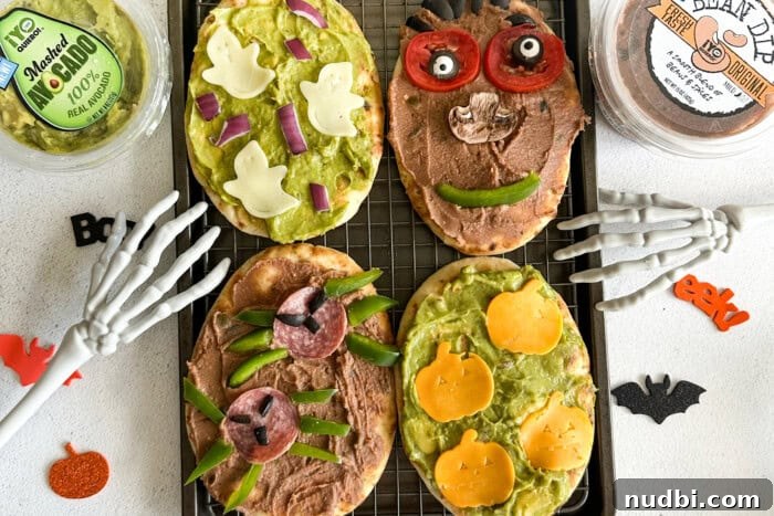 Wicked Treats and Spooky Eats 2 Flatbreads with Halloween spooky decorations like cheese ghosts and salami spiders.