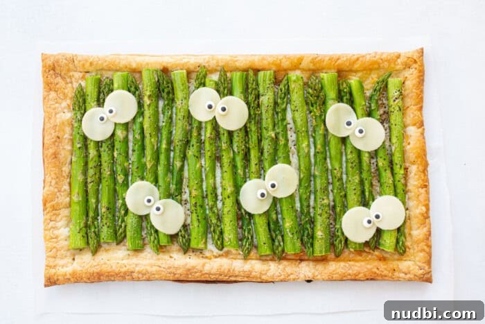 Wicked Treats and Spooky Eats 5 Flatbread with cheese and asparagus decorated with silly eyeballs