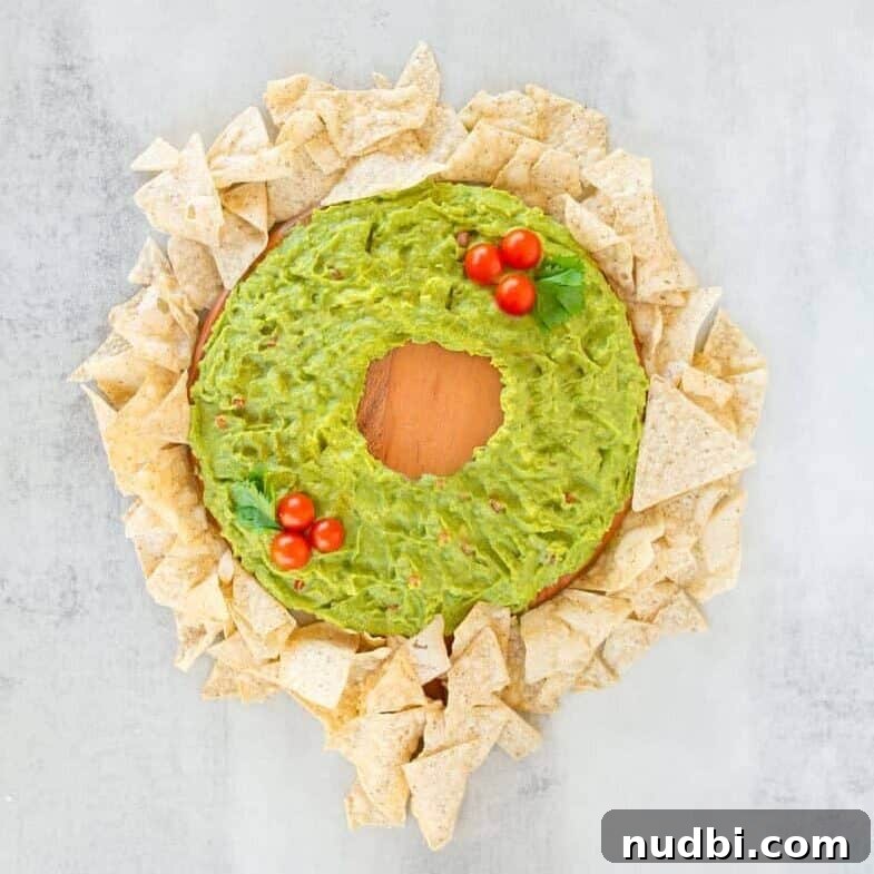 Guac Your Holidays Unexpected Festive Recipes 3 Delicious Holiday Guacamole Wreath surrounded by crunchy chips.