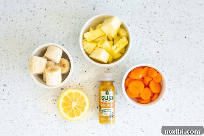 Chopped fruit in white bowls and an energy drink, ready for a healthy smoothie.