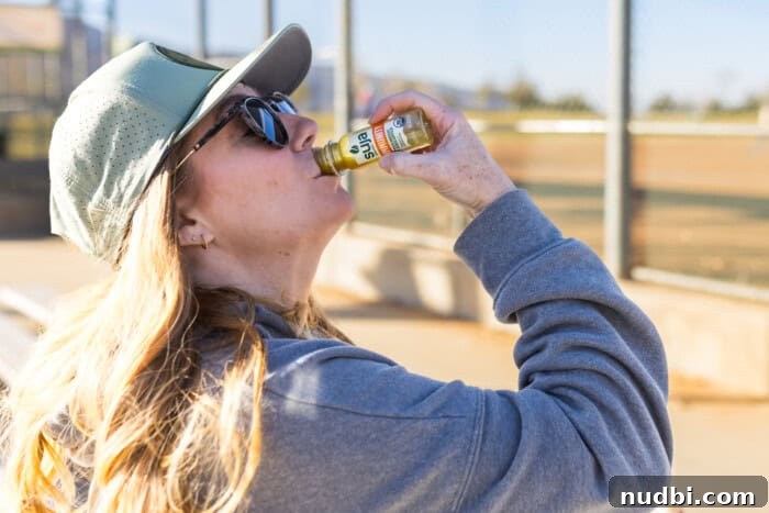 A lady drinking an immunity shot to boost her energy and overall health.