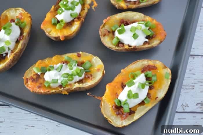Golden brown classic baked potato skins topped with sour cream and chives