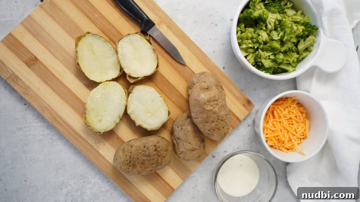Ingredients for stuffed potato skins, including a potato, cheese, and broccoli florets on a cutting board