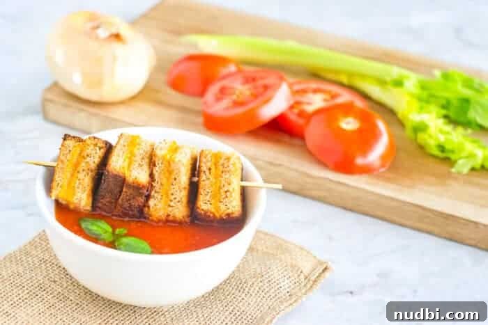 Delightful baked mini grilled cheese triangles, perfect for dipping into creamy tomato soup.