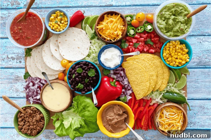 A vibrant and colorful Ultimate Taco Board featuring various proteins, vegetables, and toppings arranged for a healthy Cinco de Mayo meal.