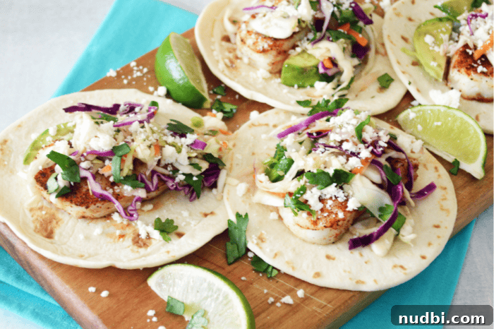 4 Epic Taco Creations for a Memorable Cinco de Mayo 3 Perfectly baked fish tacos topped with a unique watermelon rind slaw and fresh cilantro, served on a rustic wooden board with lime wedges.