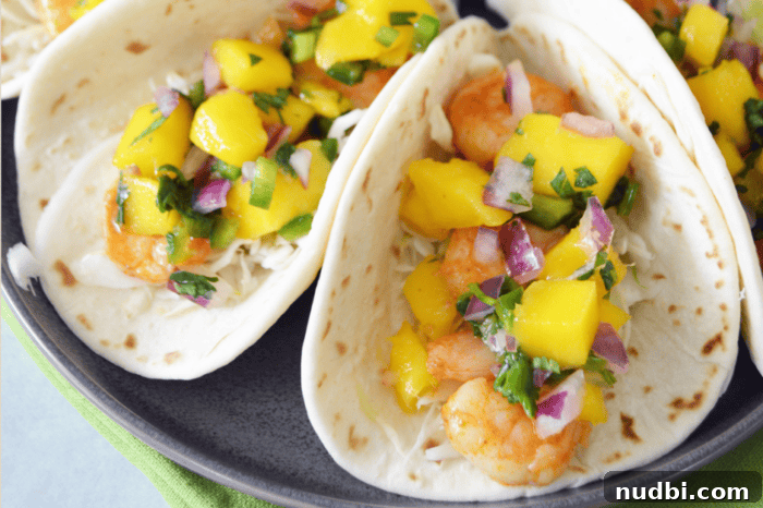4 Epic Taco Creations for a Memorable Cinco de Mayo 4 Delectable shrimp tacos adorned with bright, citrusy, and crunchy toppings, perfectly capturing the festive spirit for a Cinco de Mayo celebration.