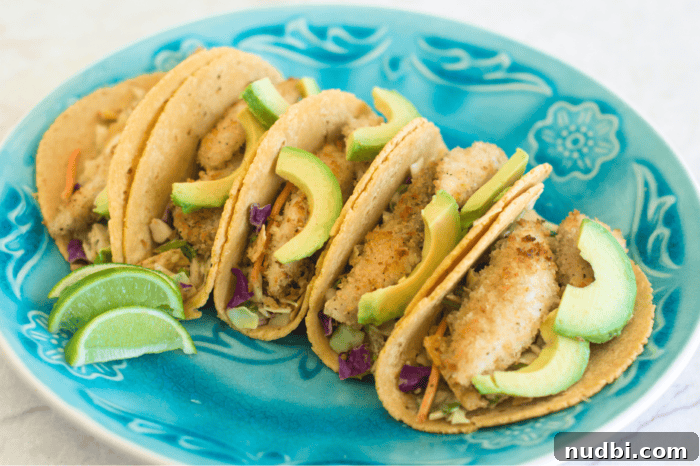 4 Epic Taco Creations for a Memorable Cinco de Mayo 5 Authentic Baja-style tacos served elegantly on a platter, generously topped with fresh avocado slices and accompanied by bright lime wedges.