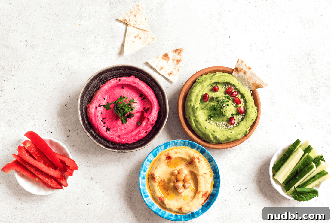 A vibrant bowl of classic hummus, garnished with fresh parsley, chickpeas, and a drizzle of olive oil, ready for dipping.