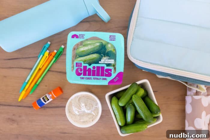 A close-up of sliced Nature Fresh Farms Lil' Chills mini cucumbers, showing their refreshing texture.