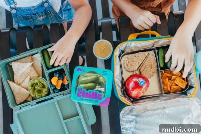 A variety of snacks, including Nature Fresh Farms Lil' Chills mini cucumbers, laid out for a family.