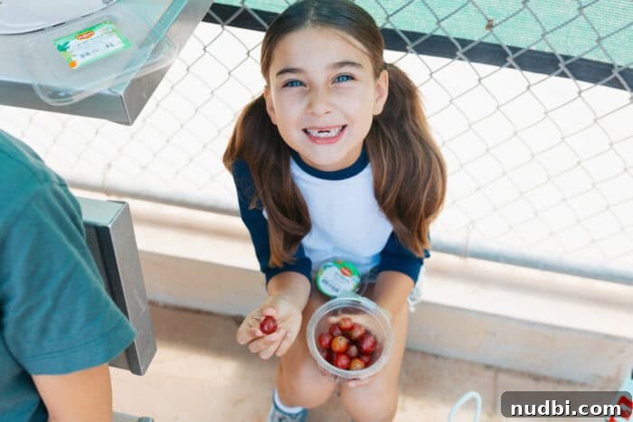 Smart Snacking: Fresh Fruit for Kids On The Go 6 A child independently choosing a Del Monte Grab and Go fruit cup from a low shelf in the refrigerator.