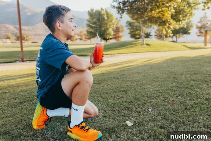 A child happily enjoying watermelon sticks, emphasizing easy hydration.