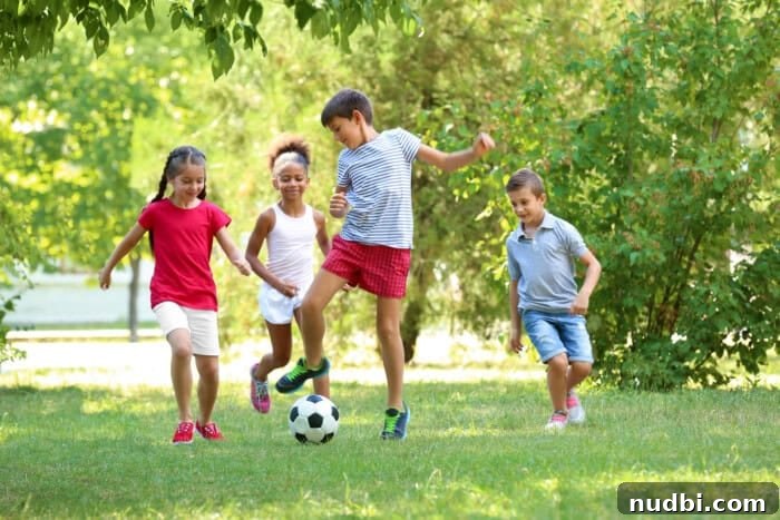 Cute children playing football in the park on a sunny Spring Break day.