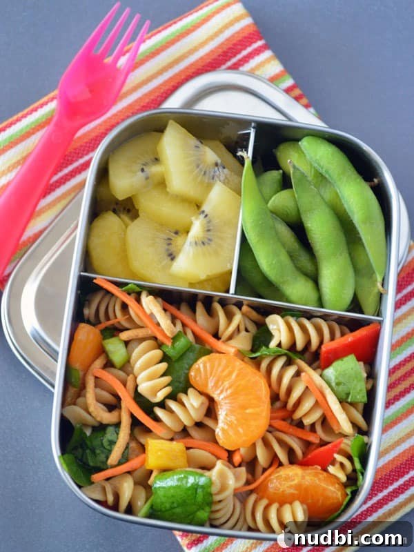Chinese Mandarin Pasta Salad Bento Box, a vibrant vegan pasta salad with mandarins and various vegetables.