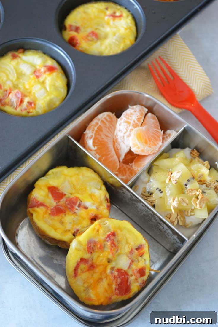 Southwest Quiche Muffins Bento Box, individual quiche muffins with a southwest flair, accompanied by fruit.