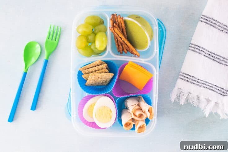 Homemade Lunchables, featuring crackers, cheese, and sliced turkey, arranged neatly in a bento box.