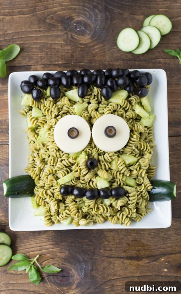 Frankenstein pasta with green pesto, cucumber 'bolts,' olives, and mozzarella eyes.