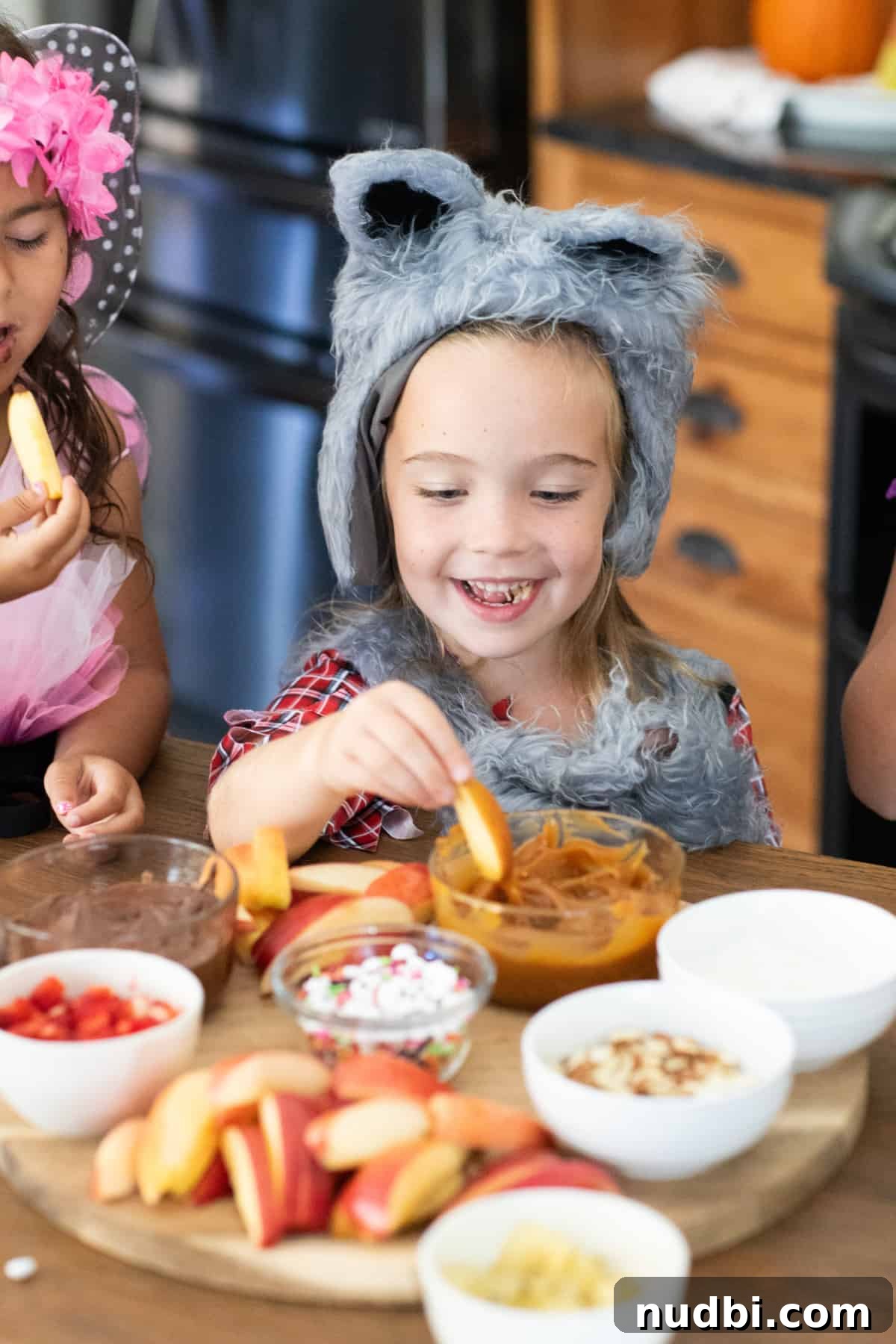Assortment of healthy and festive Halloween snacks arranged on a dark background.
